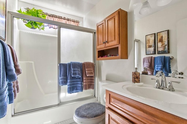 full bathroom featuring toilet, combined bath / shower with glass door, and vanity