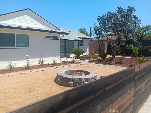 8611 Chapman Ave, Garden Grove, CA 92841 - view of front facade featuring an outdoor fire pit, fence, stucco siding, and a patio area