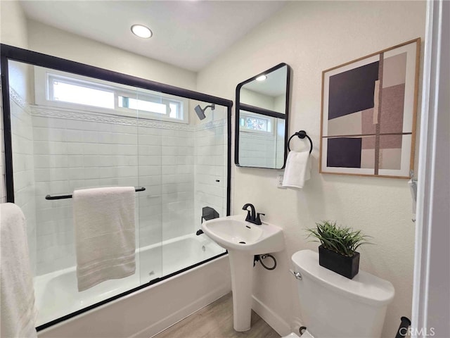 8611 Chapman Ave, Garden Grove, CA 92841 - full bathroom featuring wood finished floors, shower / bath combination with glass door, plenty of natural light, and toilet