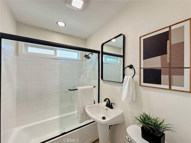 8611 Chapman Ave, Garden Grove, CA 92841 - bathroom with toilet, combined bath / shower with glass door, a textured wall, and a textured ceiling