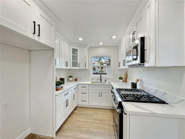 8611 Chapman Ave, Garden Grove, CA 92841 - kitchen featuring appliances with stainless steel finishes, a sink, light stone counters, white cabinets, and recessed lighting