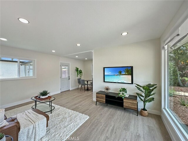8611 Chapman Ave, Garden Grove, CA 92841 - living room featuring wood finished floors, baseboards, and recessed lighting