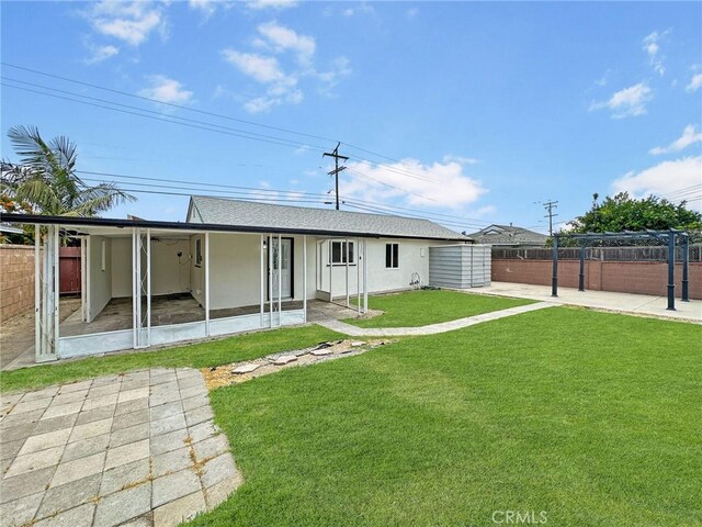 8611 Chapman Ave, Garden Grove, CA 92841 - rear view of property with stucco siding, a patio, a sunroom, and roof with shingles