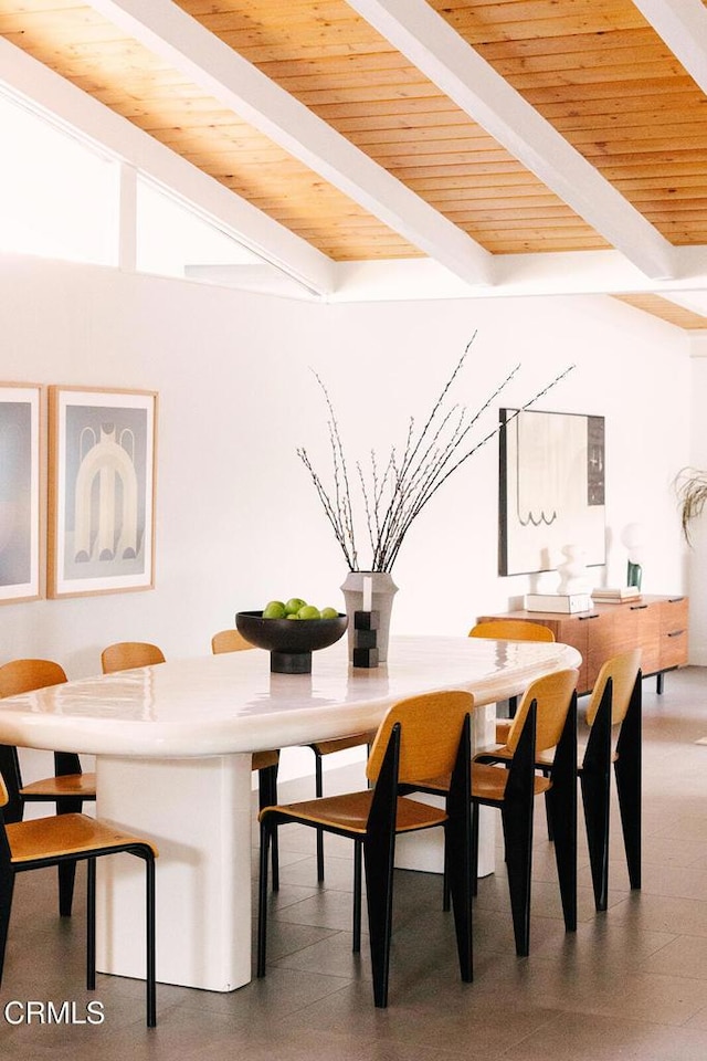 dining space with wood ceiling, tile patterned floors, and beamed ceiling