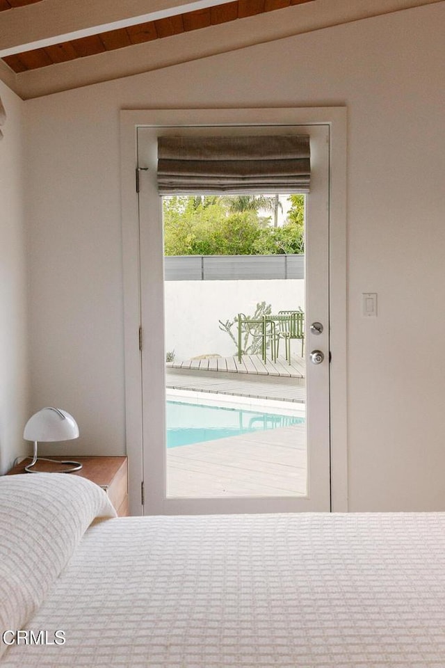 bedroom featuring access to outside and vaulted ceiling