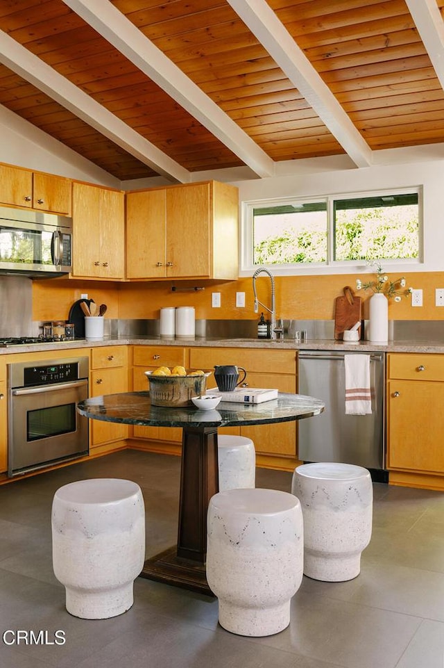 kitchen with wooden ceiling, vaulted ceiling with beams, backsplash, and stainless steel appliances