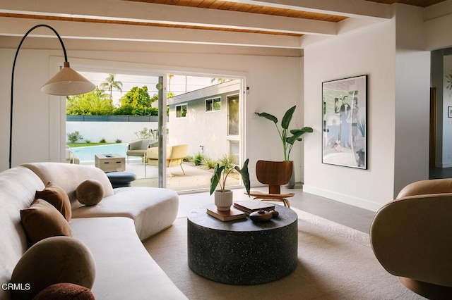living room with wooden ceiling, baseboards, and beam ceiling