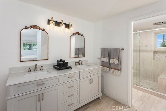 full bath with a shower stall, a sink, and marble finish floor