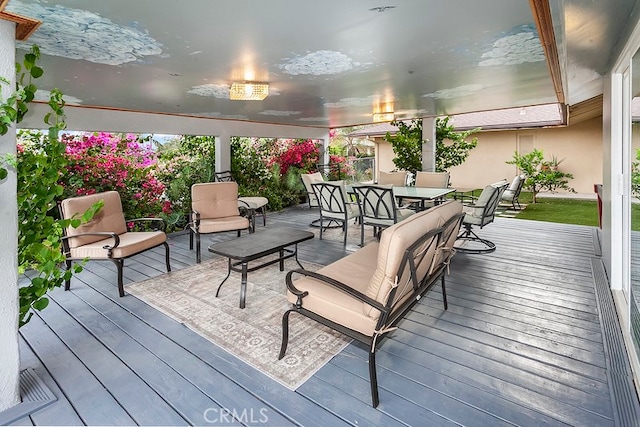 deck with outdoor dining area