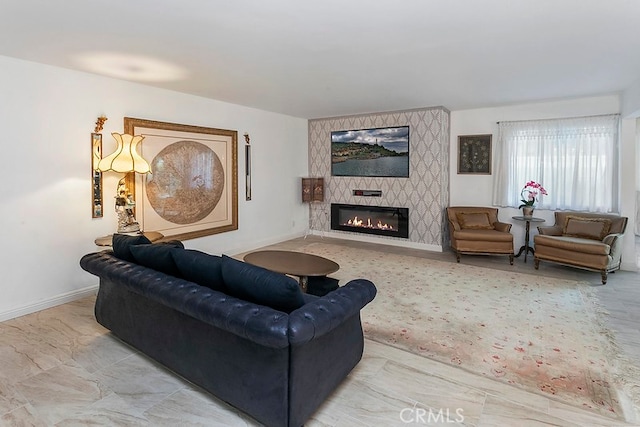 living room featuring baseboards and a fireplace