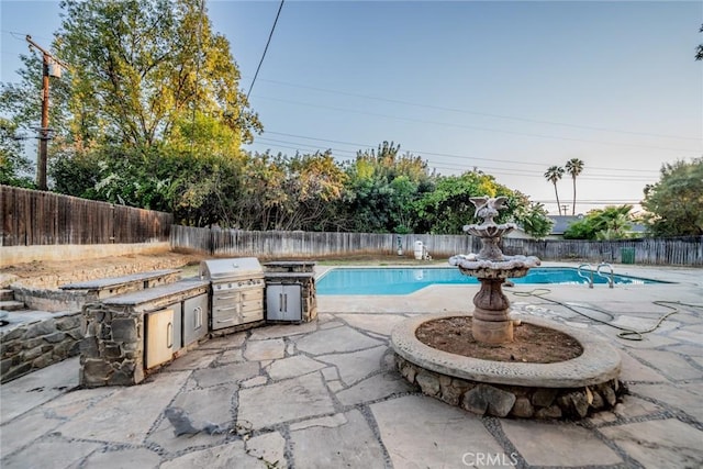 view of swimming pool with a fenced backyard, a patio area, and area for grilling