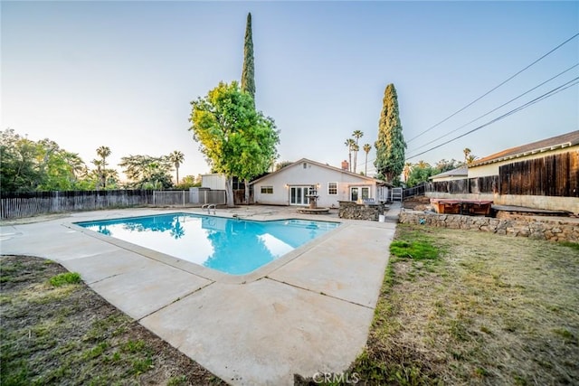 view of swimming pool featuring a hot tub, a patio, a fenced in pool, and a fenced backyard