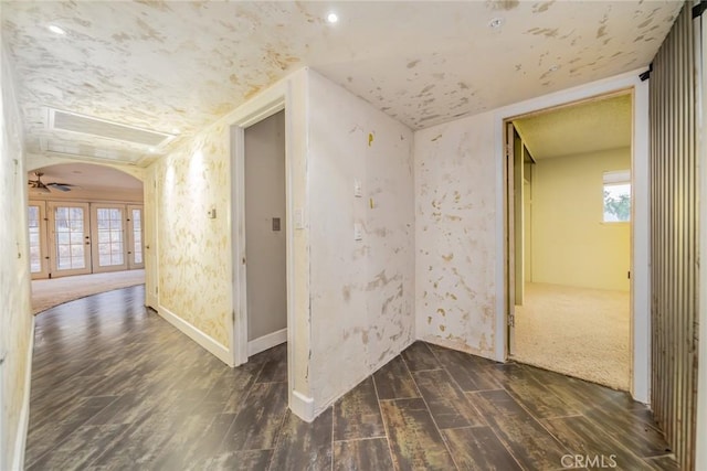 corridor with french doors, dark wood-style floors, and a wealth of natural light