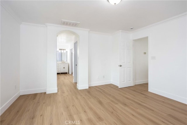 347 Beckes St, Wasco, CA 93280 - unfurnished room featuring visible vents, arched walkways, light wood-style flooring, and ornamental molding