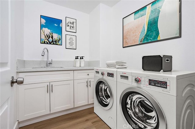 347 Beckes St, Wasco, CA 93280 - washroom featuring a sink, cabinet space, light wood finished floors, and independent washer and dryer