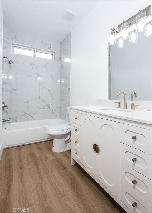 347 Beckes St, Wasco, CA 93280 - bathroom featuring vanity, toilet, wood finished floors, and shower / washtub combination