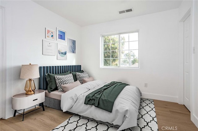 347 Beckes St, Wasco, CA 93280 - bedroom with baseboards, visible vents, and wood finished floors