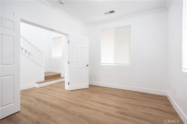 347 Beckes St, Wasco, CA 93280 - unfurnished room featuring visible vents, ornamental molding, stairs, baseboards, and light wood-style flooring