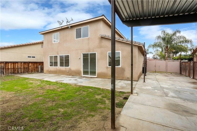 347 Beckes St, Wasco, CA 93280 - rear view of property featuring a fenced backyard, a patio, stucco siding, and a yard
