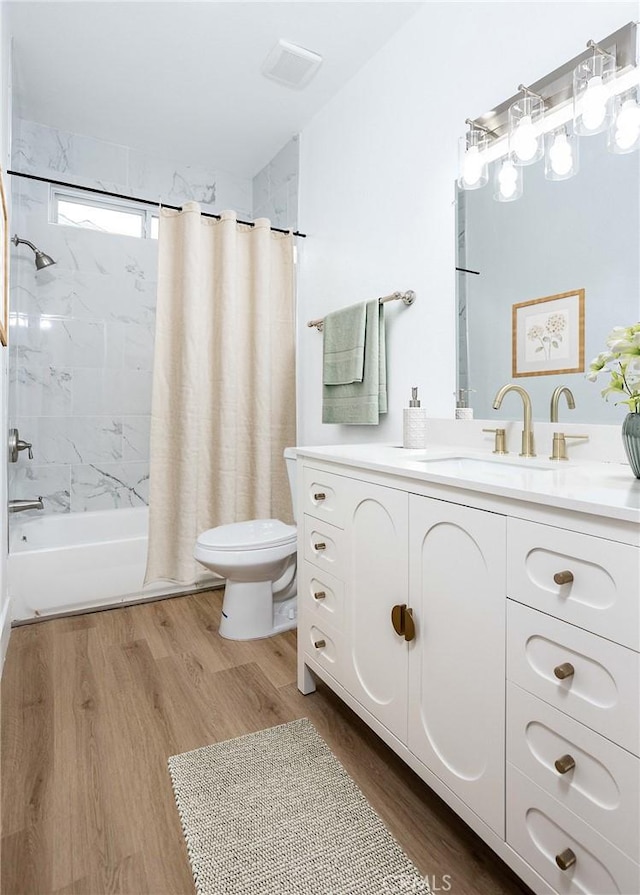 347 Beckes St, Wasco, CA 93280 - full bathroom featuring vanity, toilet, shower / bath combination with curtain, wood finished floors, and visible vents