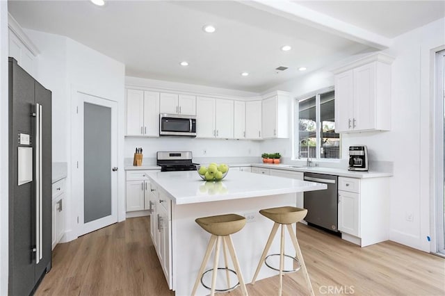 347 Beckes St, Wasco, CA 93280 - kitchen featuring a sink, appliances with stainless steel finishes, white cabinets, and light wood finished floors