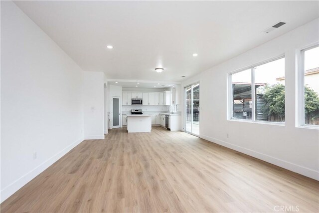 347 Beckes St, Wasco, CA 93280 - unfurnished living room with recessed lighting, baseboards, visible vents, and light wood-style flooring