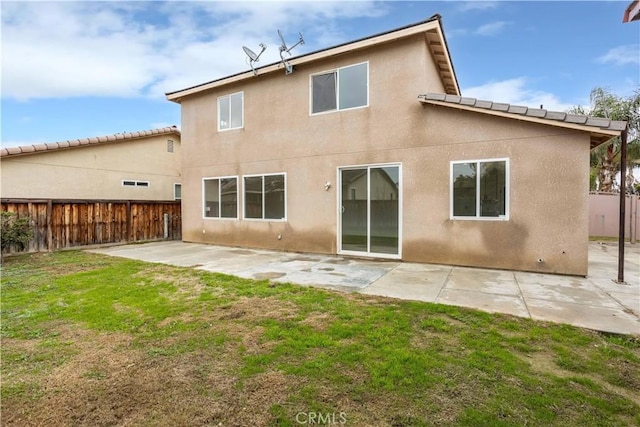 347 Beckes St, Wasco, CA 93280 - rear view of property featuring fence, stucco siding, a lawn, and a patio area