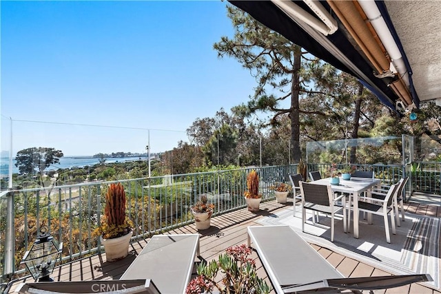 view of patio featuring outdoor dining area and a balcony