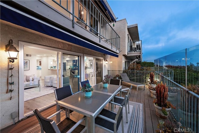 wooden deck with outdoor dining space and visible vents