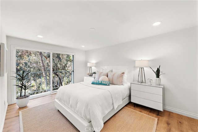 bedroom featuring baseboards, recessed lighting, and wood finished floors