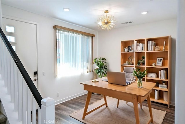 office space featuring a notable chandelier, visible vents, dark wood-style floors, and baseboards