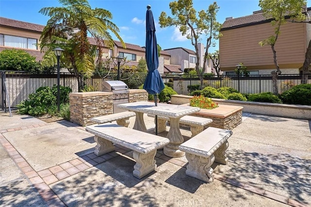 view of patio / terrace featuring area for grilling, a residential view, outdoor dining area, and a fenced backyard