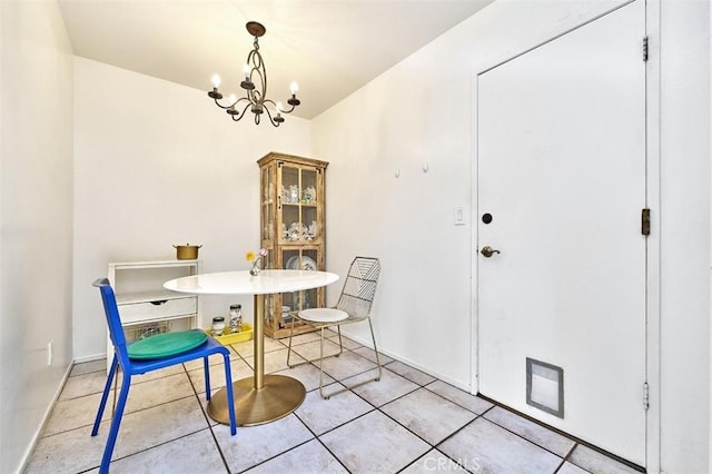 tiled dining area with a chandelier