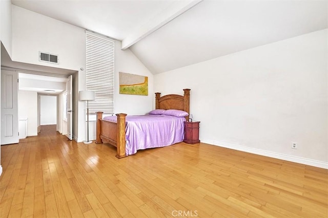 bedroom featuring vaulted ceiling with beams, baseboards, visible vents, and light wood-style flooring