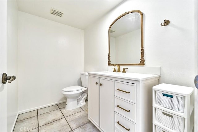bathroom with visible vents, tile patterned flooring, vanity, baseboards, and toilet