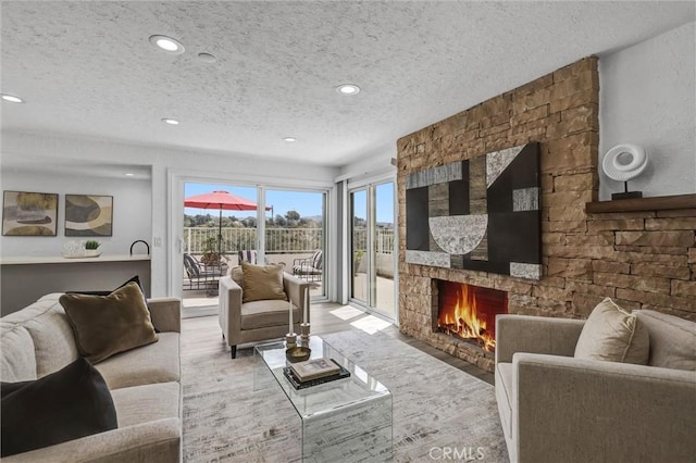 3118 Calle Grande, San Clemente, CA 92672 - living room featuring a textured ceiling, wood finished floors, a stone fireplace, and recessed lighting