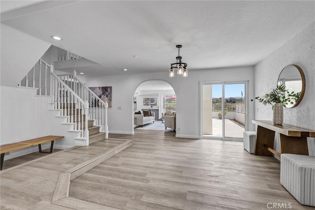 3118 Calle Grande, San Clemente, CA 92672 - foyer featuring stairway, wood finished floors, arched walkways, and recessed lighting