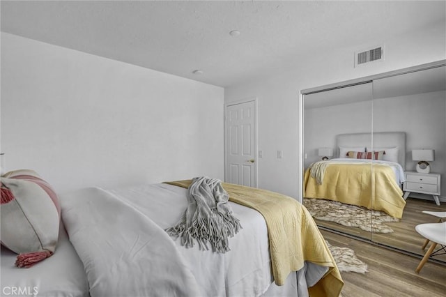 3118 Calle Grande, San Clemente, CA 92672 - bedroom featuring a closet, visible vents, and wood finished floors