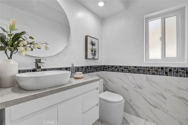 3118 Calle Grande, San Clemente, CA 92672 - bathroom featuring tile walls, toilet, marble finish floor, wainscoting, and vanity