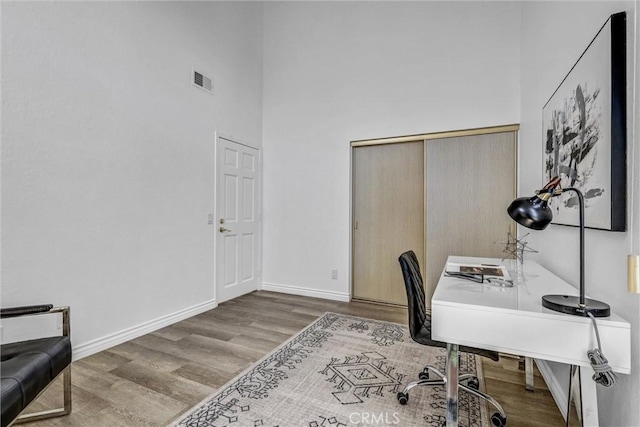 3118 Calle Grande, San Clemente, CA 92672 - home office featuring a towering ceiling, baseboards, visible vents, and wood finished floors