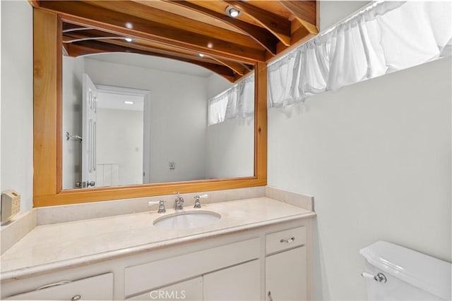 bathroom featuring vanity and toilet