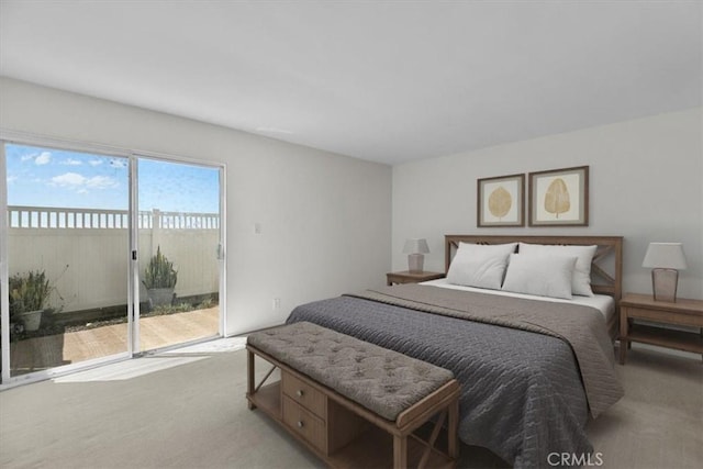 bedroom featuring light carpet and access to exterior