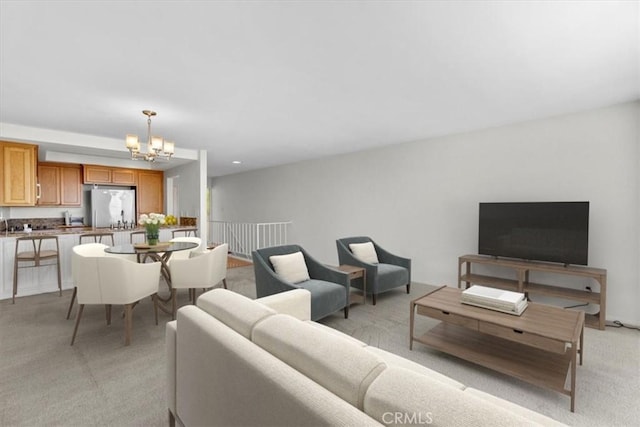 living area with a chandelier and light colored carpet