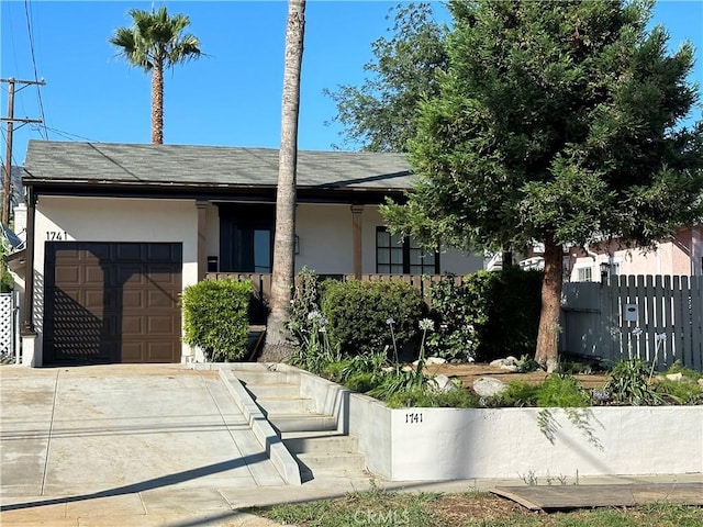 1741 Glenwood Rd, Glendale, CA 91201 - view of front of property with stucco siding, fence, a garage, and concrete driveway