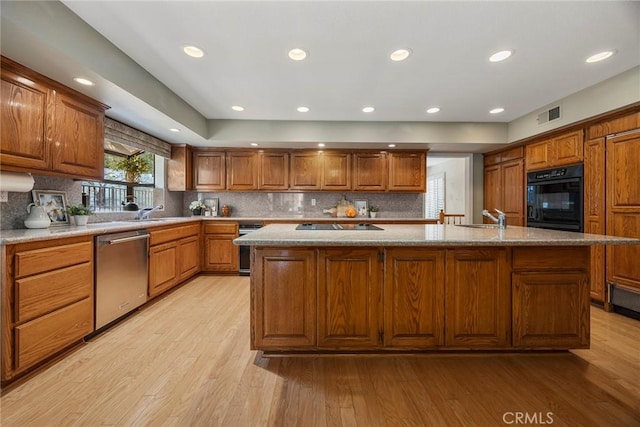 112 Morgan Ranch Rd, Glendora, CA 91741 - kitchen with black appliances, a sink, light wood-type flooring, brown cabinetry, and backsplash