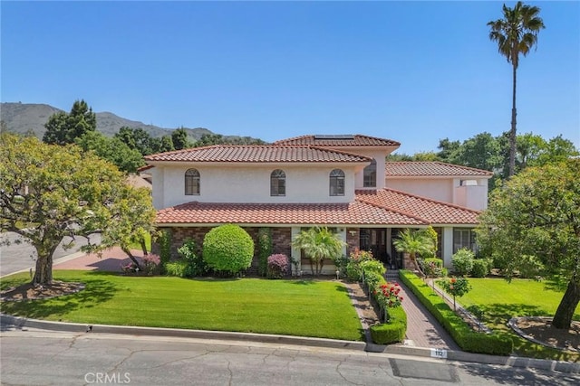 112 Morgan Ranch Rd, Glendora, CA 91741 - mediterranean / spanish home featuring solar panels, a tiled roof, a front yard, and stucco siding