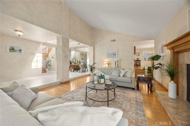 112 Morgan Ranch Rd, Glendora, CA 91741 - living area with visible vents, high vaulted ceiling, a notable chandelier, light wood-style floors, and stairs