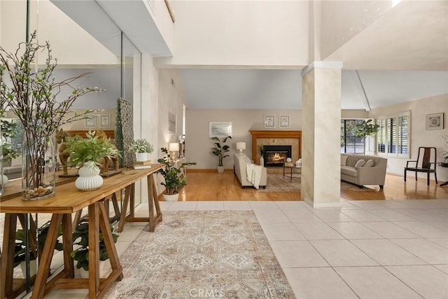 112 Morgan Ranch Rd, Glendora, CA 91741 - entryway with decorative columns, a tiled fireplace, high vaulted ceiling, baseboards, and light tile patterned flooring