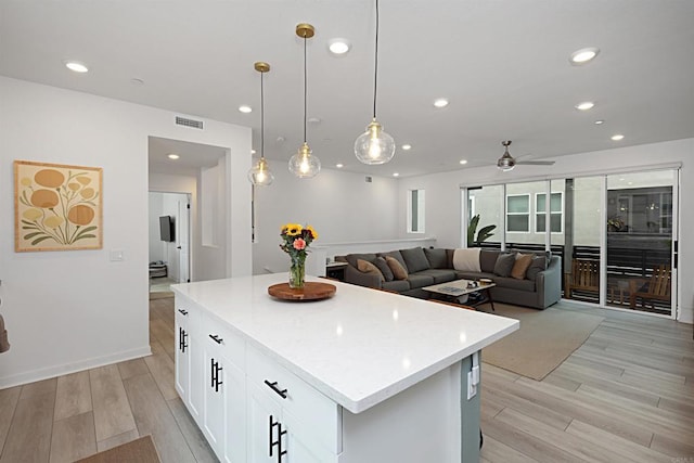 10456 Newbliss Way, Mira Mesa, CA 92126 - kitchen with light wood-type flooring, a kitchen island, a ceiling fan, white cabinets, and recessed lighting