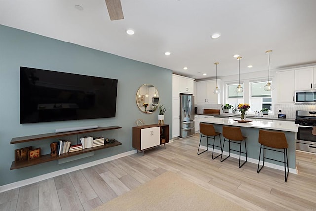 10456 Newbliss Way, Mira Mesa, CA 92126 - kitchen featuring appliances with stainless steel finishes, a breakfast bar, white cabinetry, decorative backsplash, and recessed lighting
